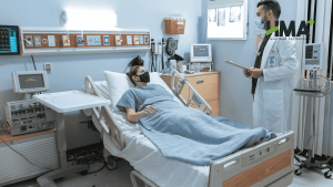 A Woman Lying In A Hospital Bed With A Doctor Standing Next To Her